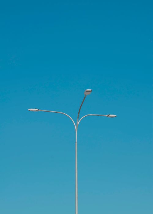Free A street lamp captured against a vibrant blue sky in Dubai, United Arab Emirates. Stock Photo