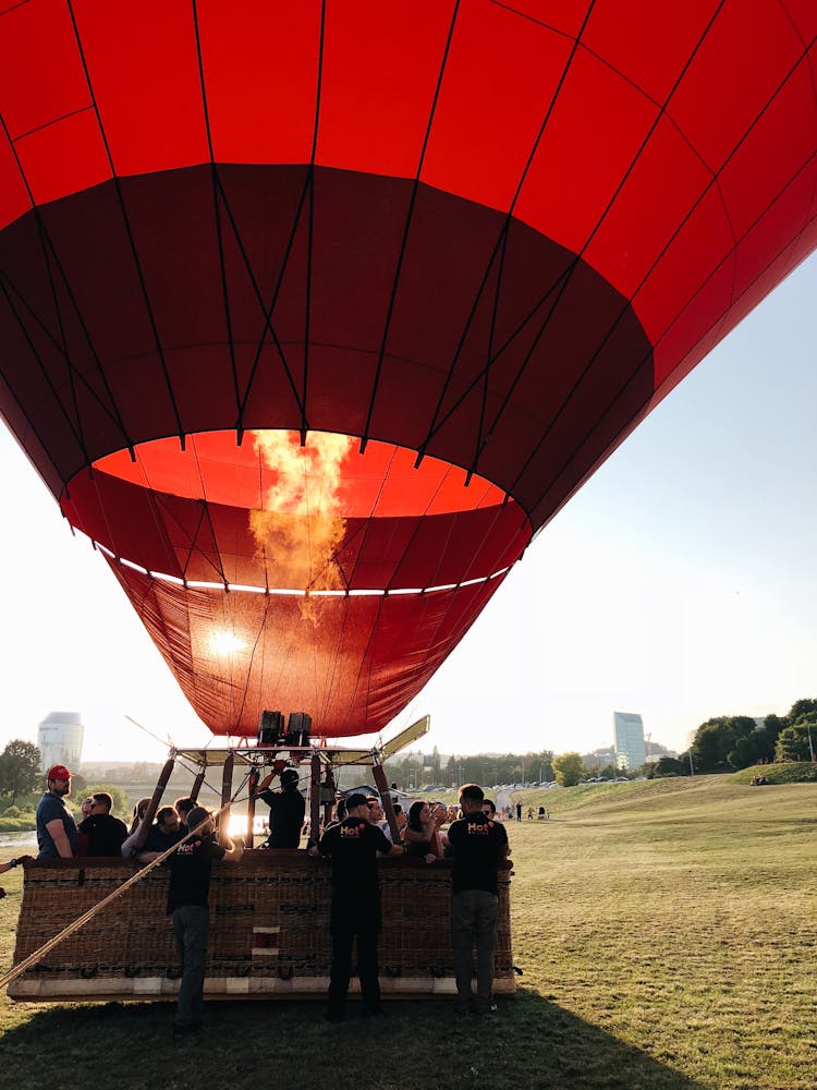 People Gathered Around Red Hot Air Balloon