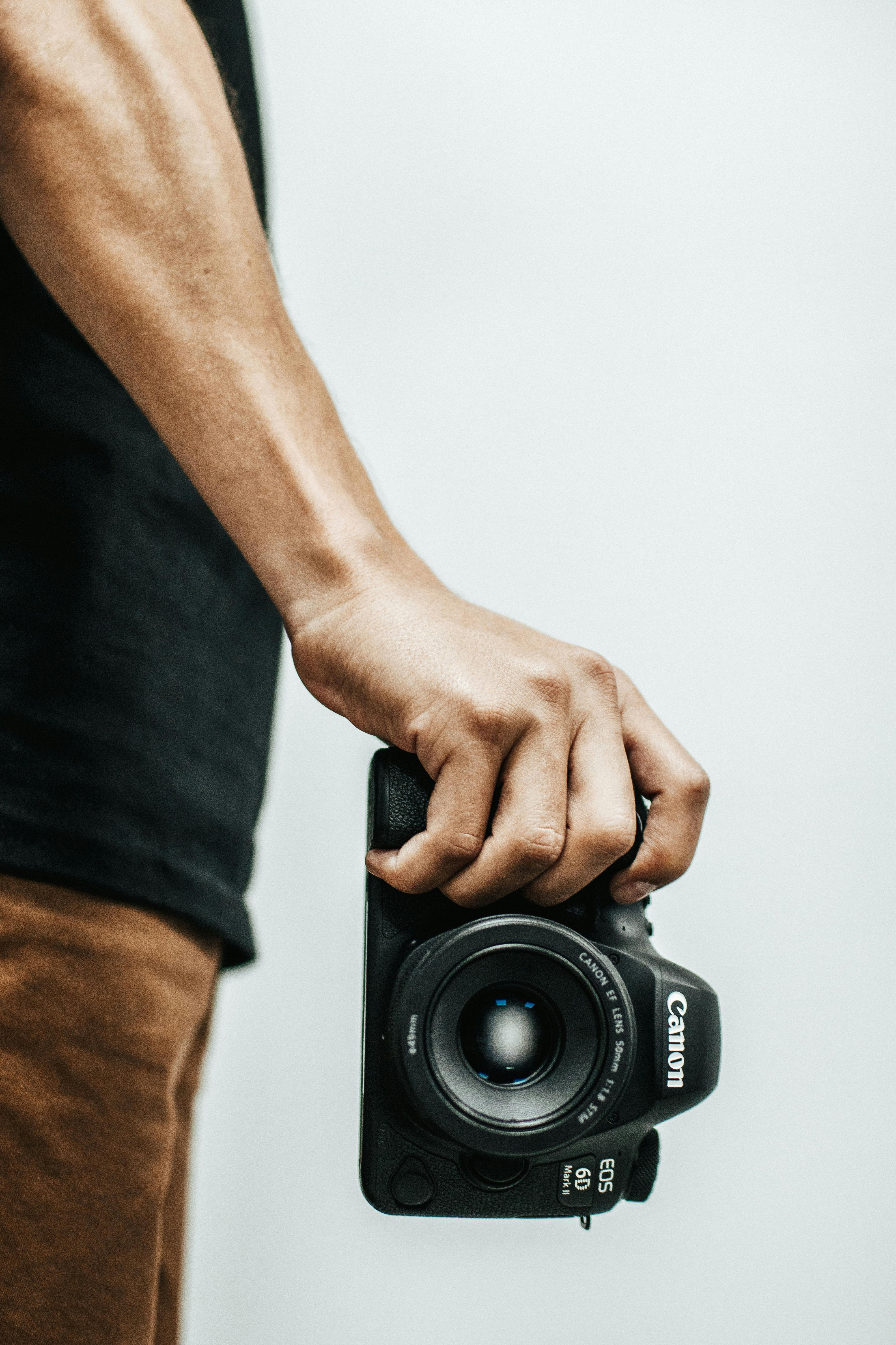 Person Holding Canon Dslr Camea · Free Stock Photo