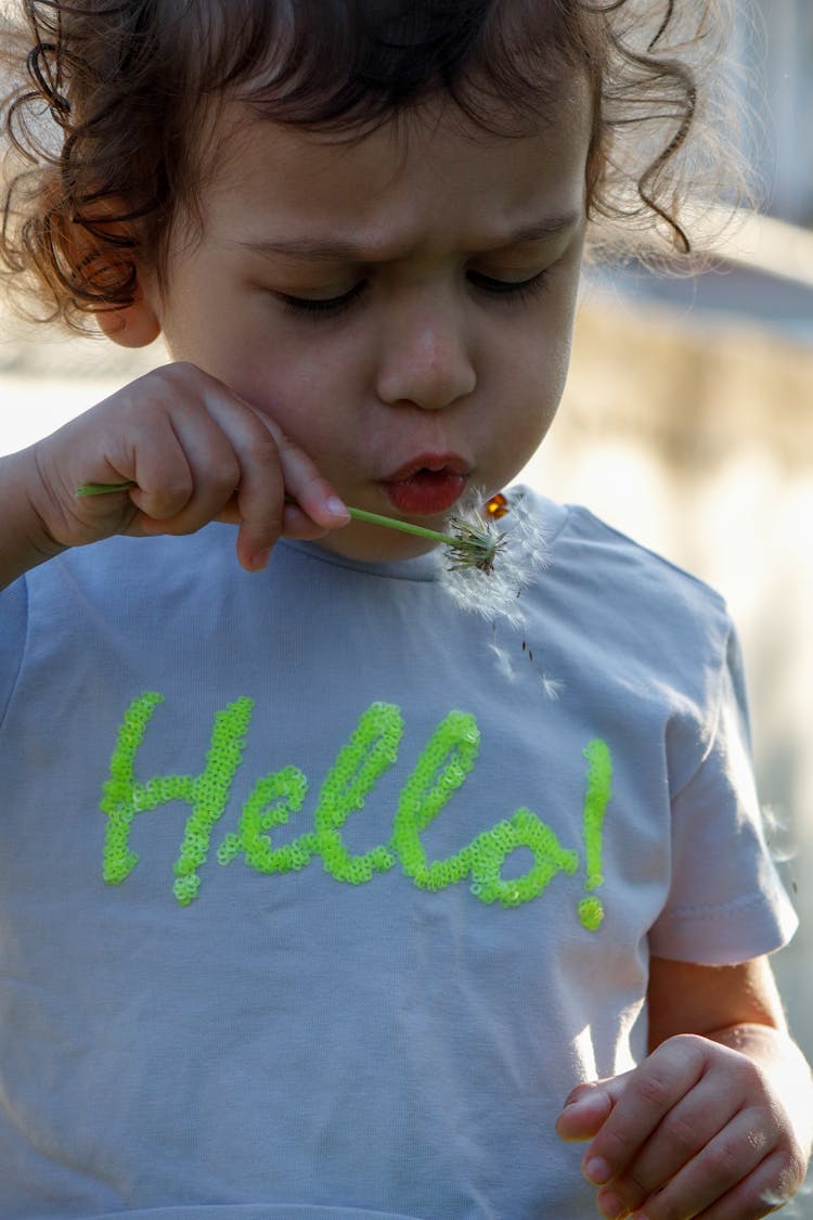 Child Blowing Dandelion