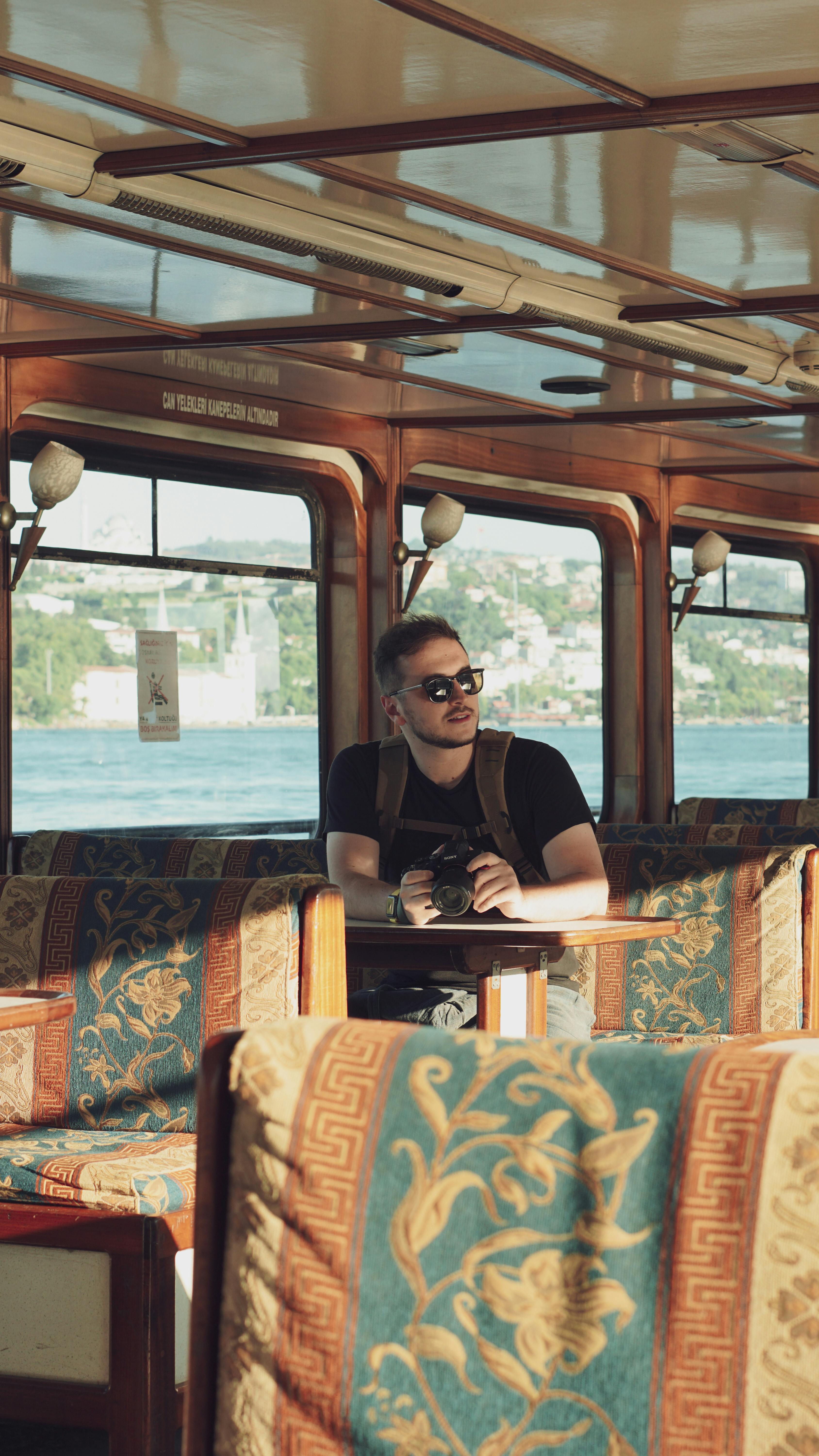 a man sitting on a boat with a view of the water