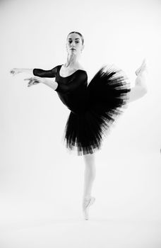 Graceful ballerina performing a classic ballet pose with elegance and poise.