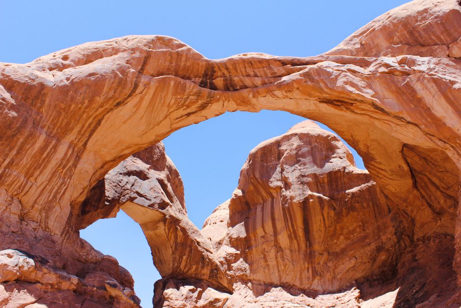 A breathtaking view of Double Arch in Utah's Arches National Park with clear blue skies.