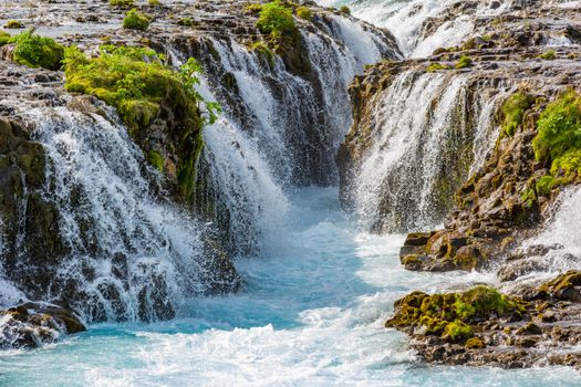 Captivating view of Bruarfoss waterfalls, Iceland's hidden gem with vibrant blue water.