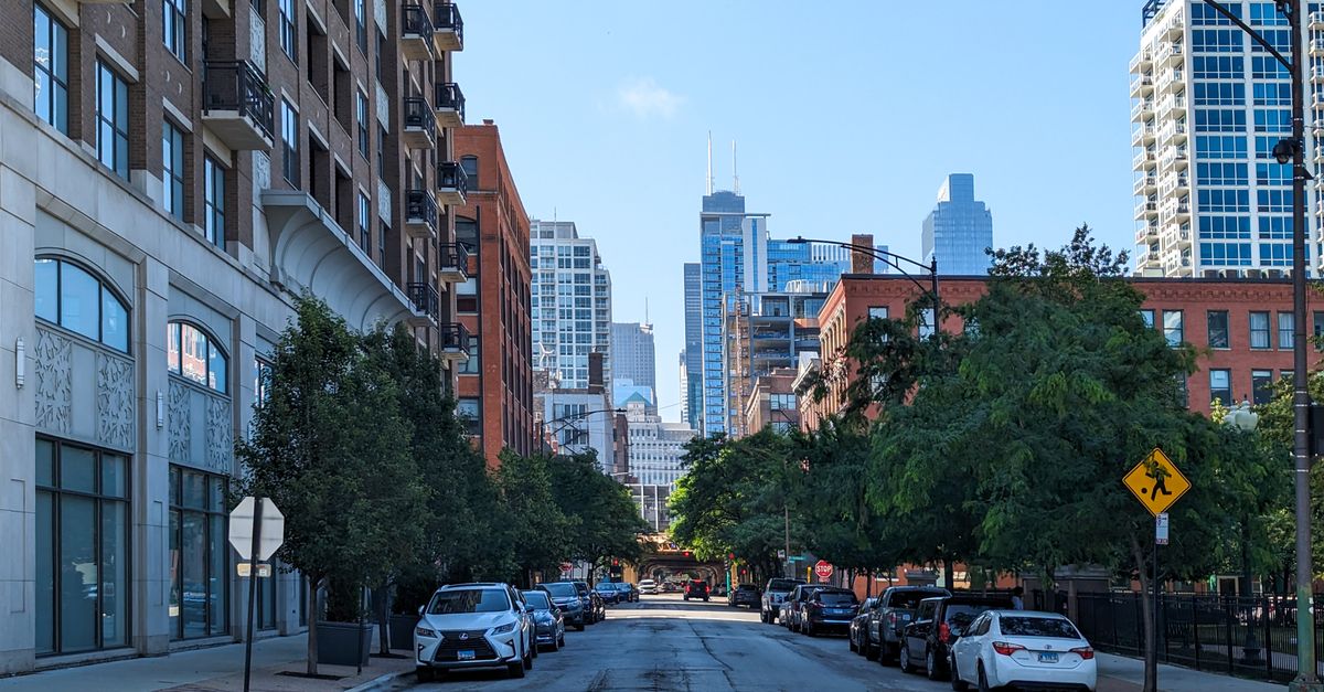 Street view in Chicago showcasing urban architecture and iconic skyline on a clear day.