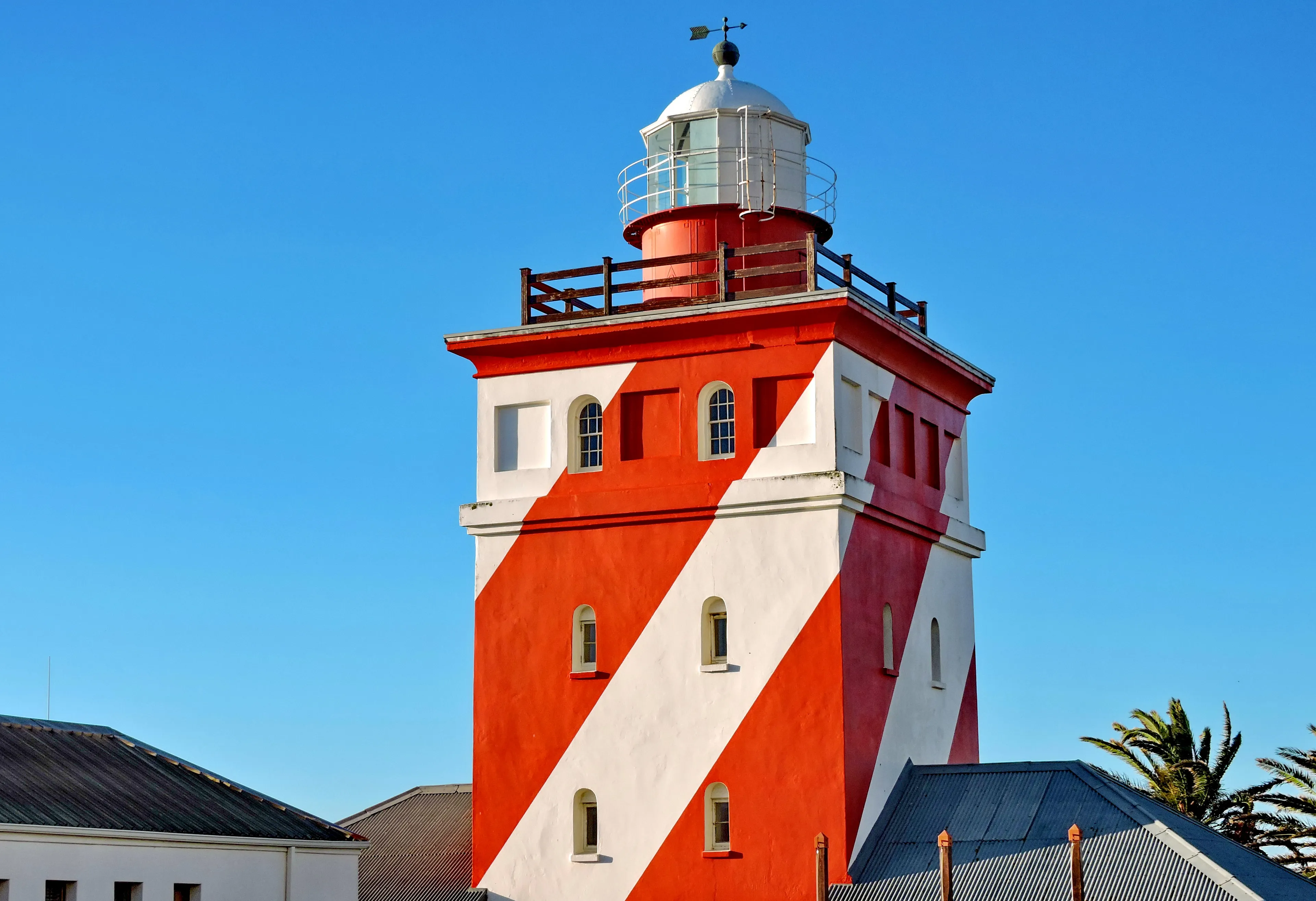 The red-and-white striped Green Point lighthouse on the Sea Point promenade coastline