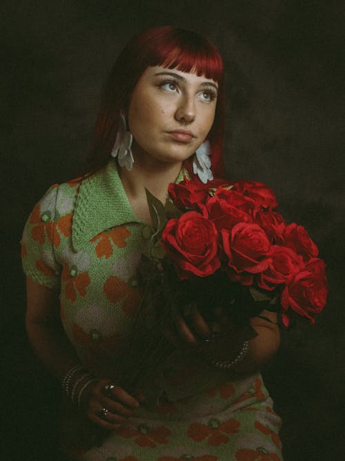 Young Woman Holding a Bouquet of Red Roses 