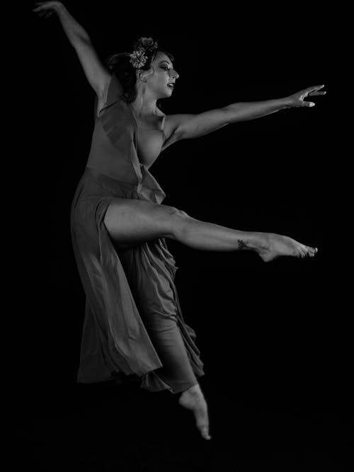 A Dancer Doing a Pose Midair 