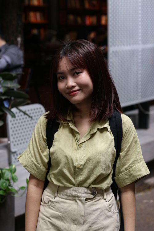Free Asian woman enjoying a day out in the city, captured in a candid and joyful moment. Stock Photo