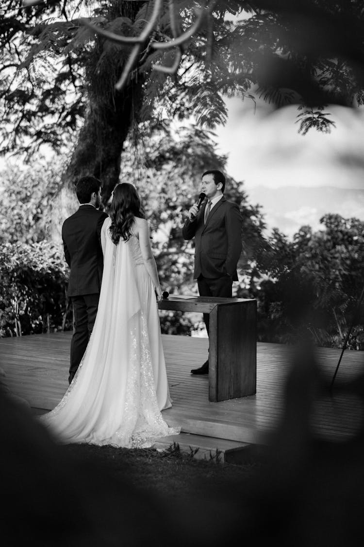 Bride, Groom And The Officiant At The Wedding 