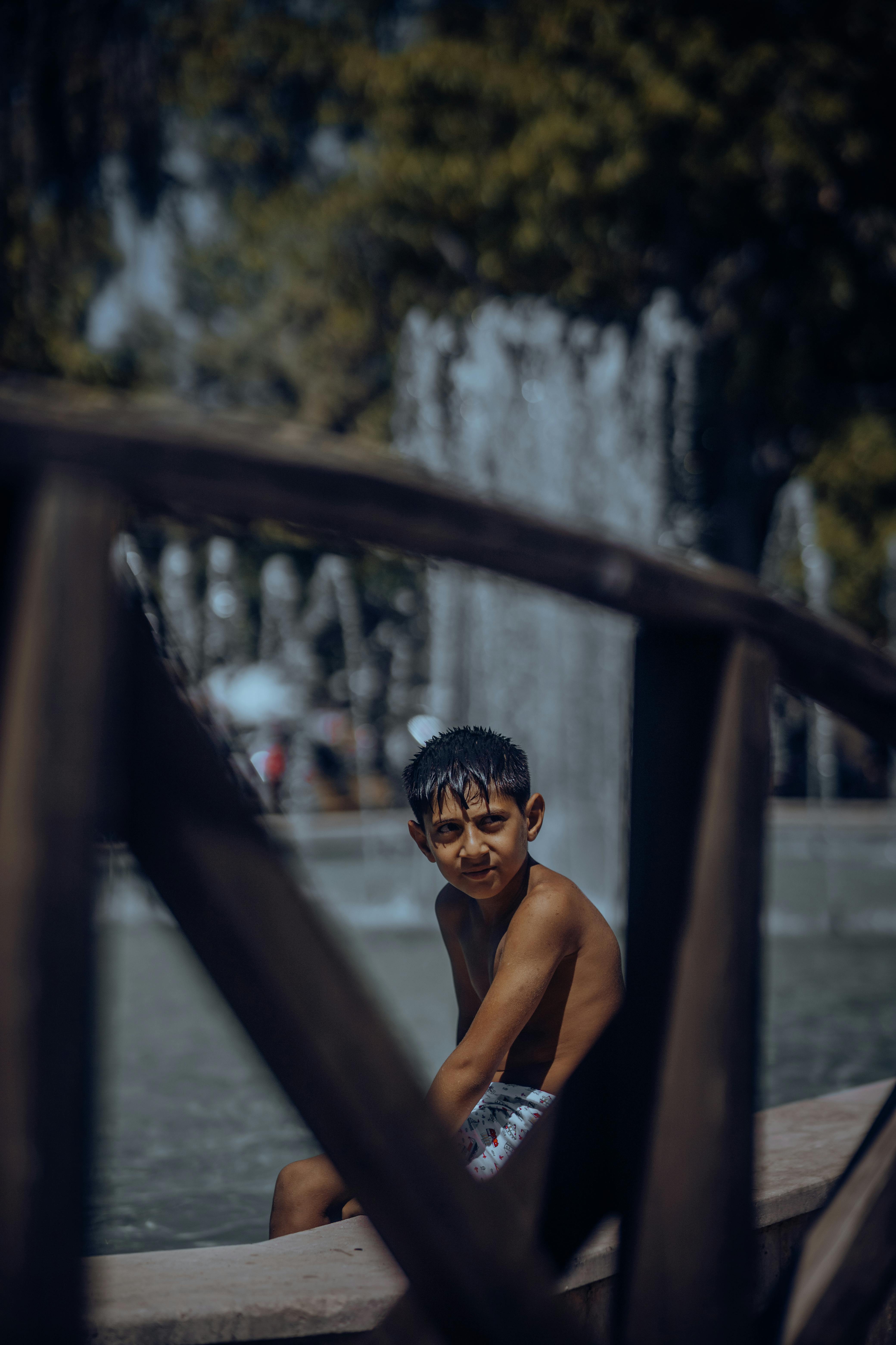 Little Boy Sitting near Swimming Pool · Free Stock Photo