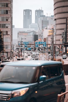 Dynamic street scene in Tokyo with modern architecture and lively urban traffic.