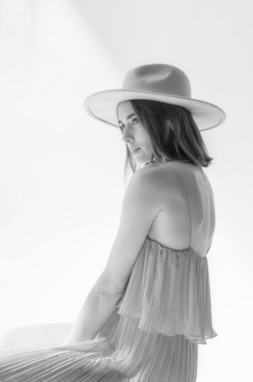 Pretty Young Woman in a Dress and a Hat