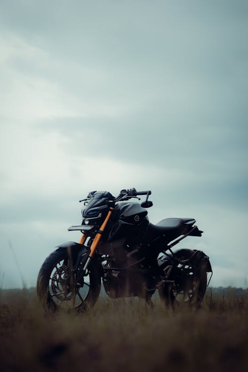 Black Motorcycle under Clouds