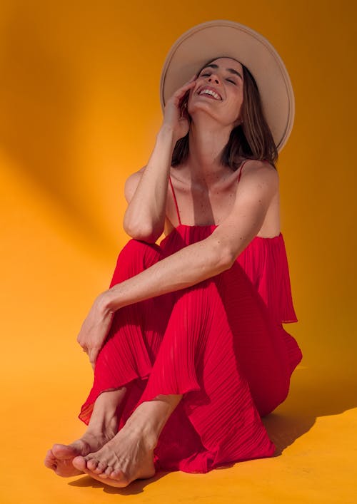 Smiling Woman in Hat and Red Dress