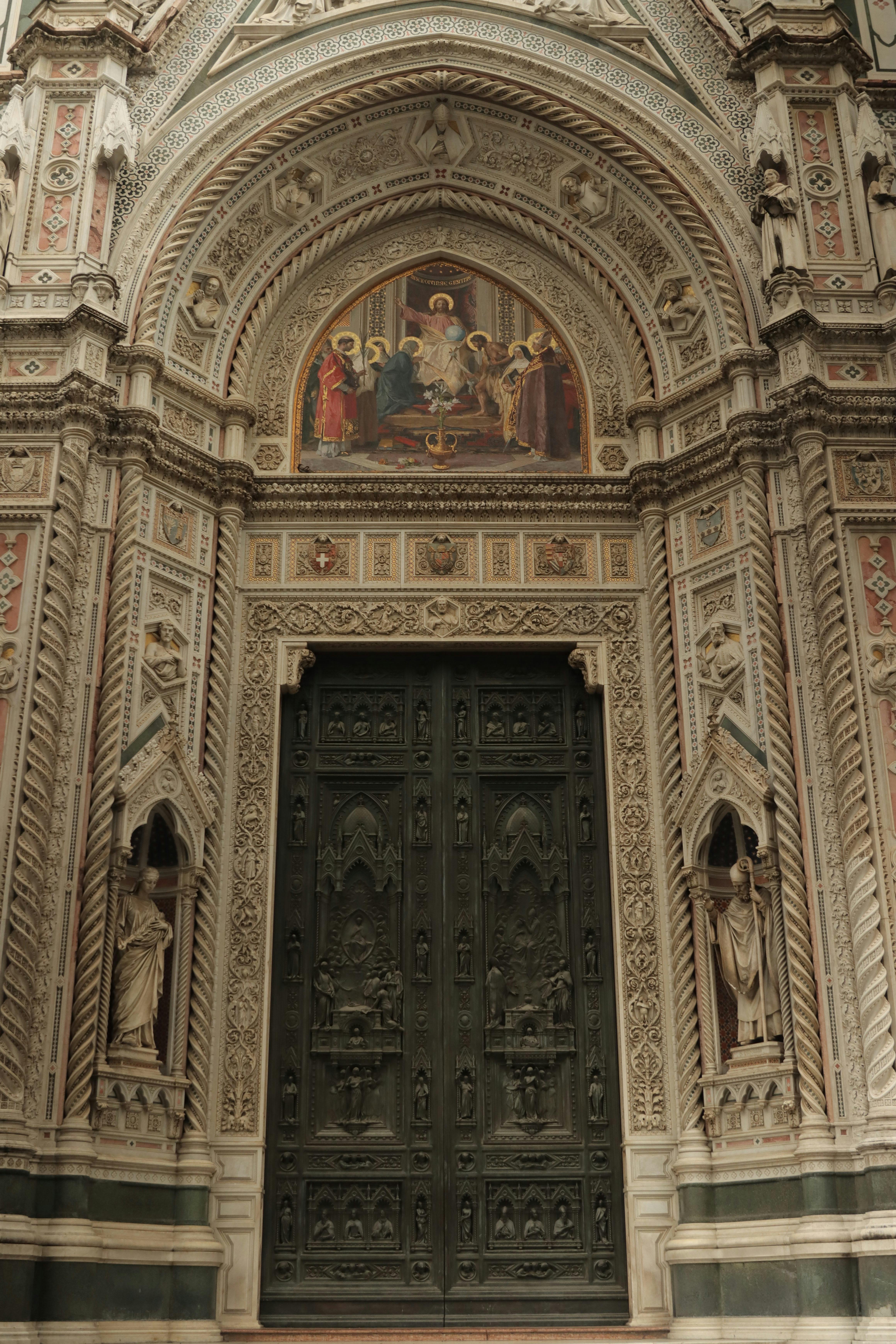 Intricate facade of the Florence Cathedral showcasing Gothic architecture with detailed sculptures and artwork.