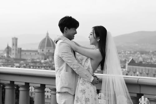 Black and White Photograph of Newlyweds Standing on a Terrace, and Florence Cityscape in Background