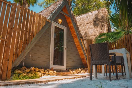 A cozy A-frame cabin surrounded by lush greenery in Kemer, Antalya, Türkiye.