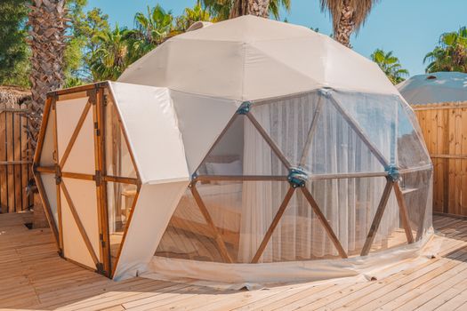 Experience modern glamping in a geodesic dome amidst lush greenery in Kemer, Türkiye.