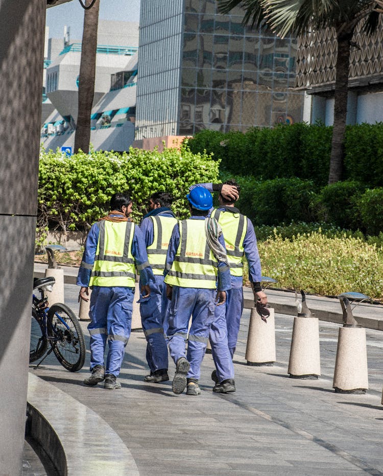 Workers Walking On Pavement