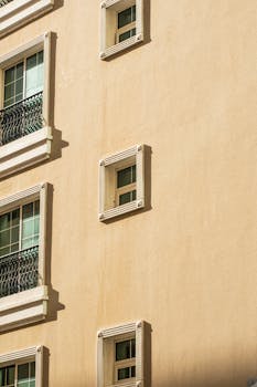 Close-up of a modern residential building facade with detailed windows and balconies.