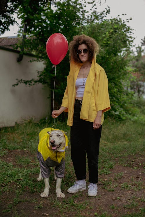 Woman in Shirt Standing with Dog in Clothes