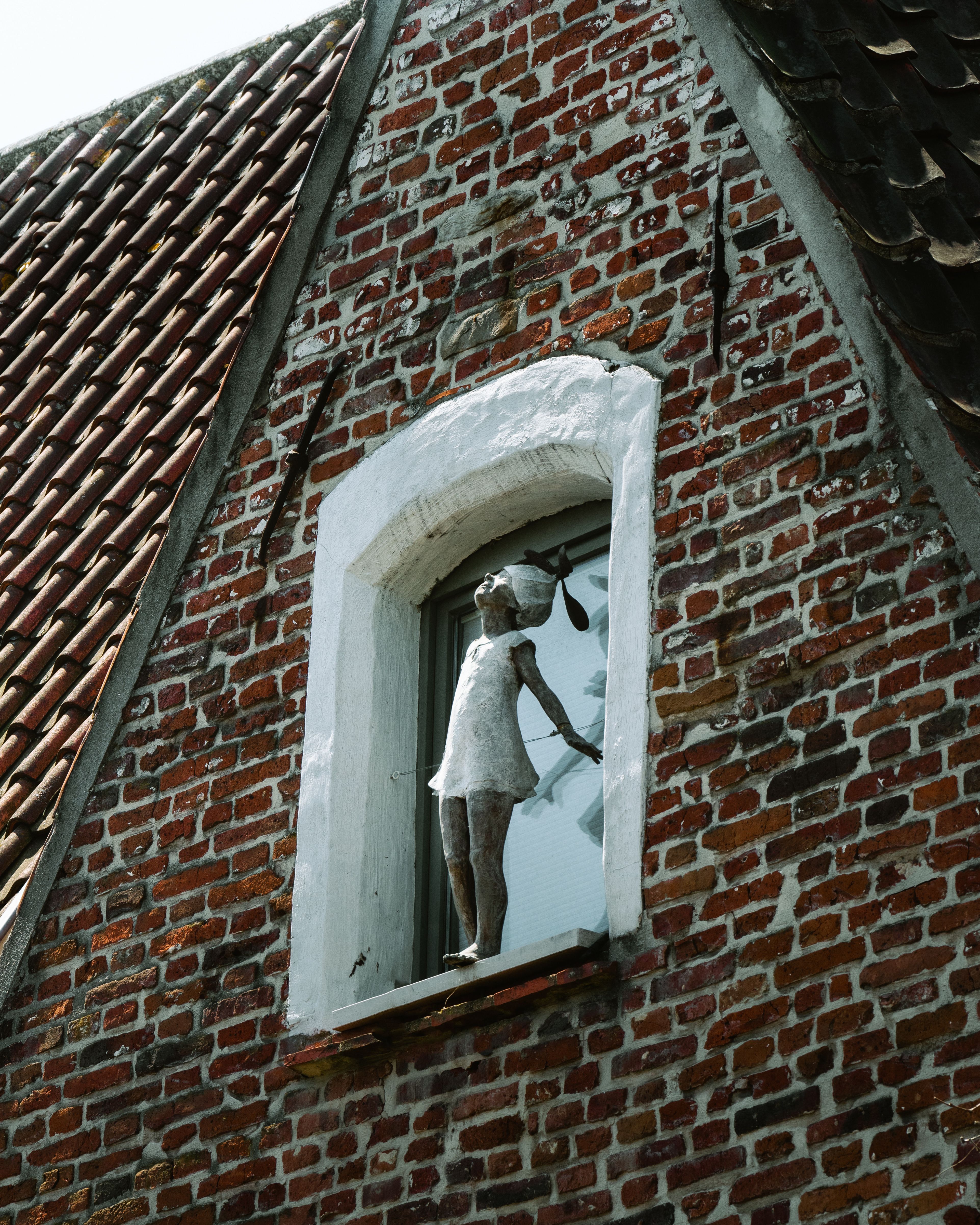 Sculpture in Building Window · Free Stock Photo