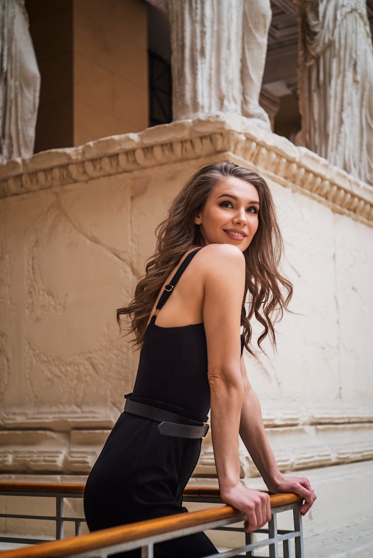 A Woman Wearing Black Dress On A Balcony