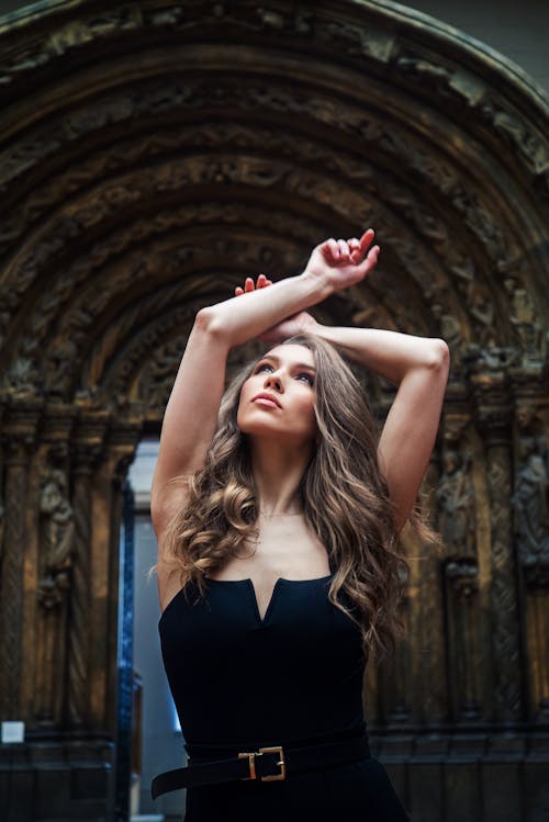 Woman Posing with Arms Raised