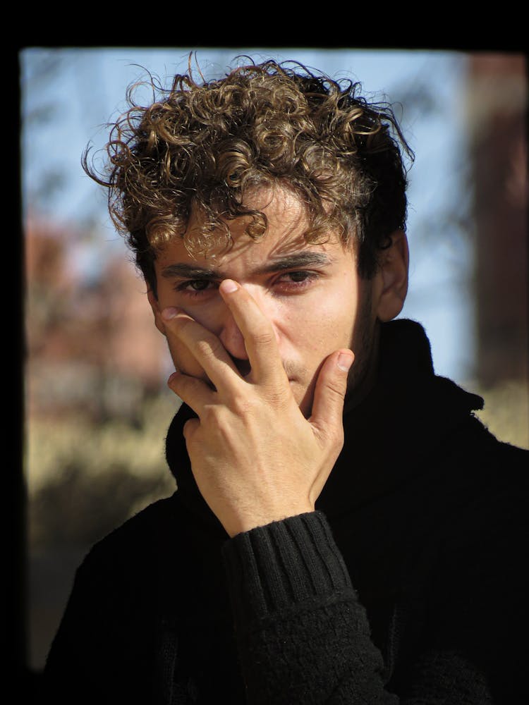 A Portrait Of A Man Wearing Black Sweater