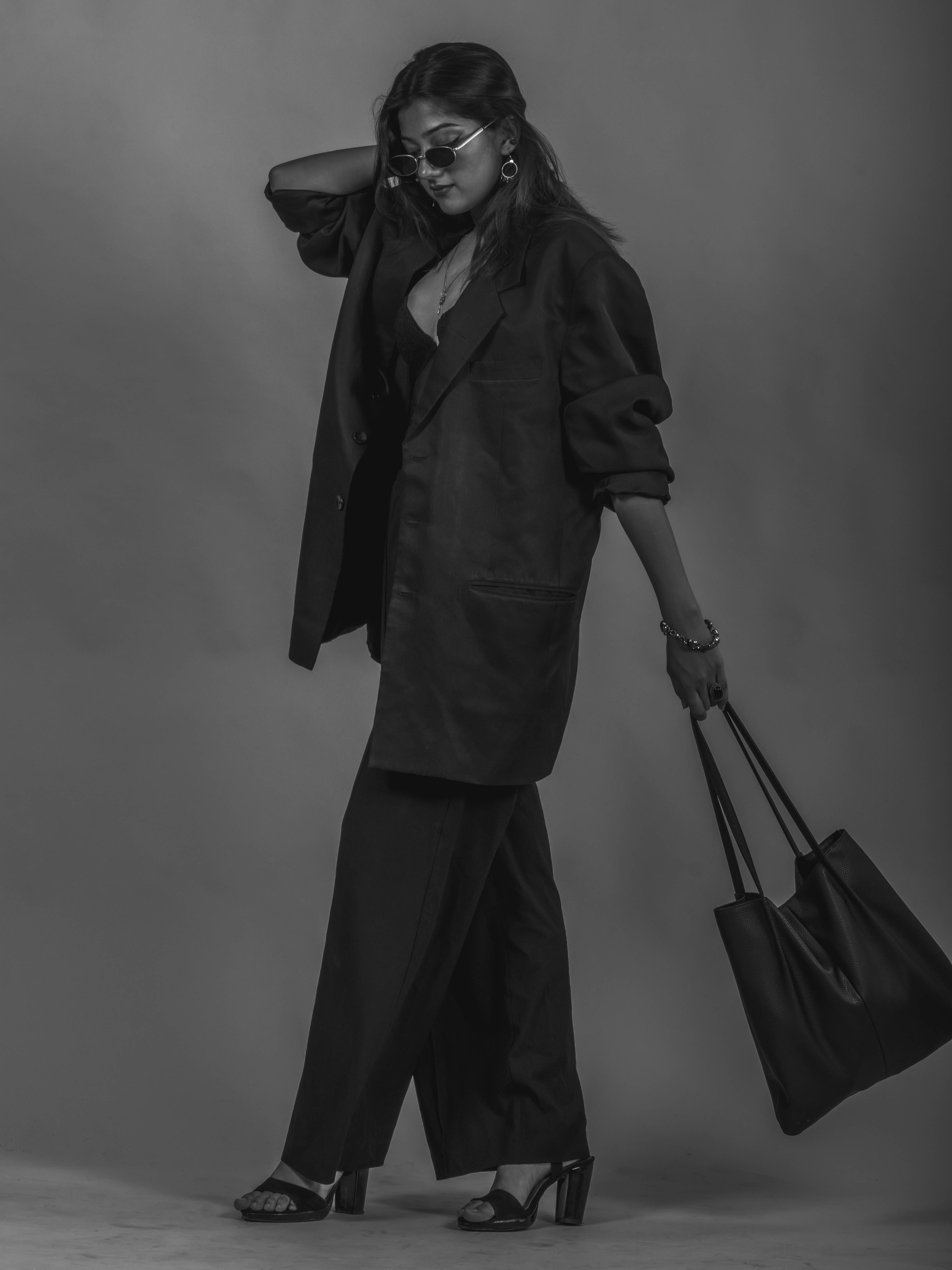 Elegant woman in suit with structured handbag — travel-ready and composed