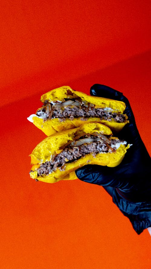 Free Hand in Glove Holding Burgers Stock Photo