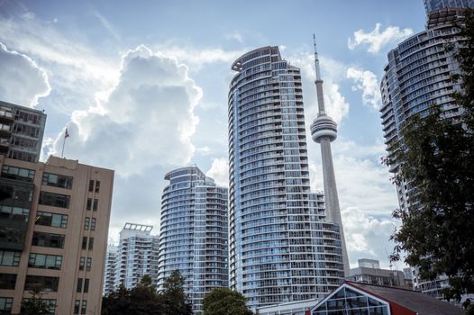 Stunning view of Toronto's skyline with CN Tower under a cloudy sky.