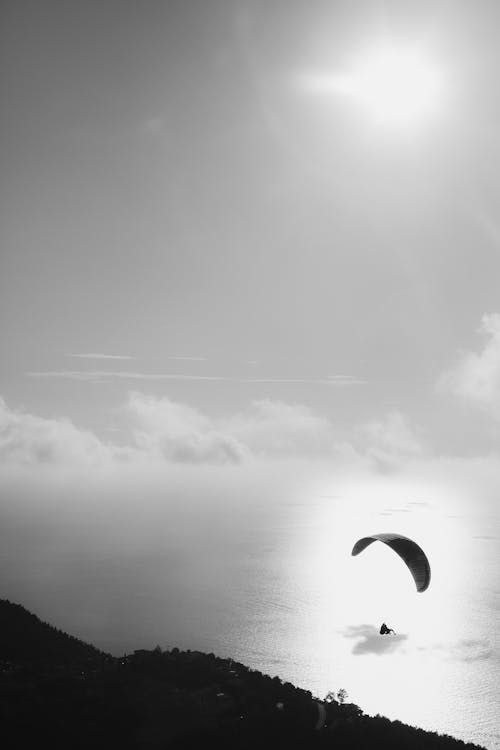 Parachuting over Sea Coast in Black and White