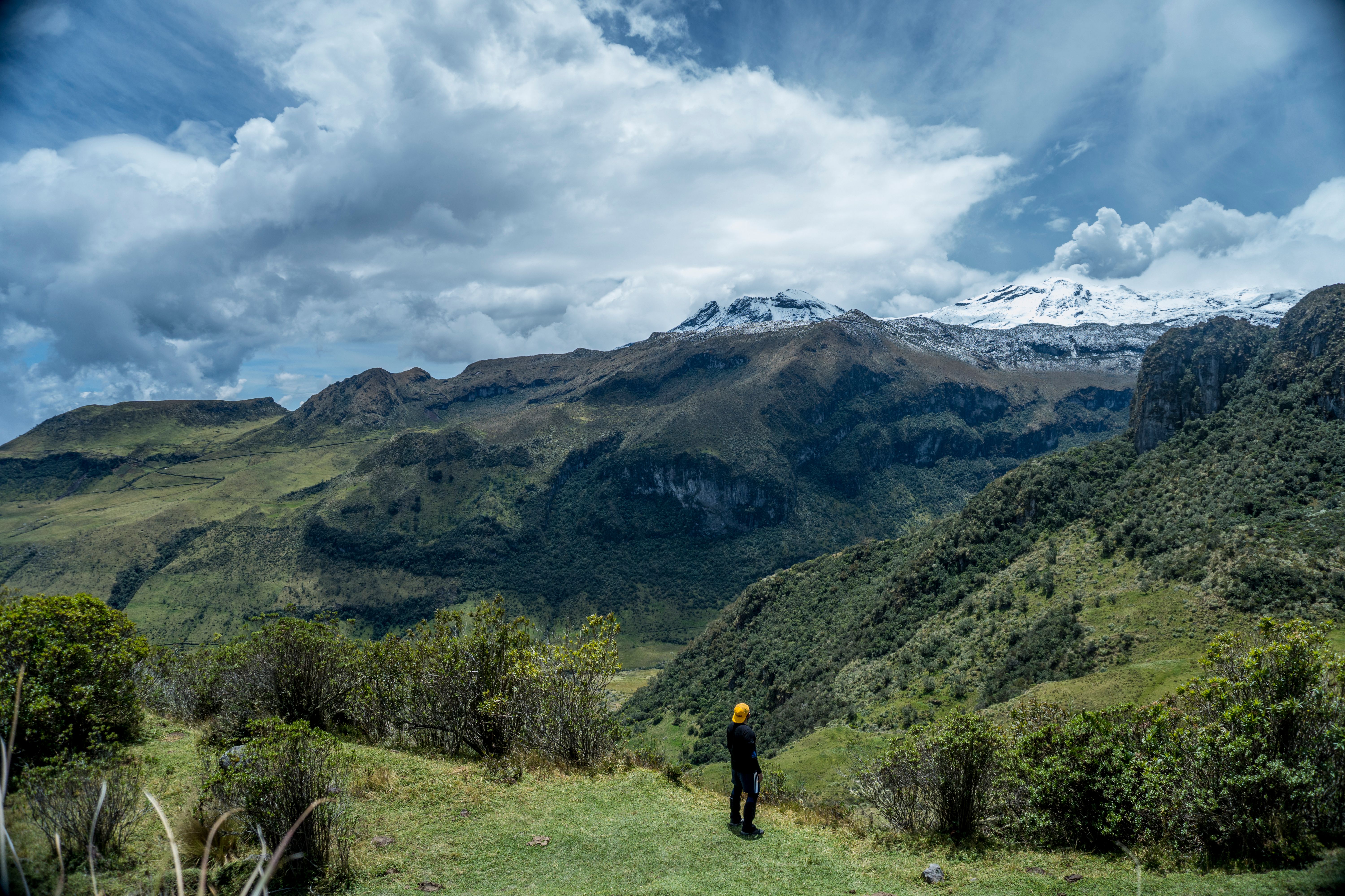 Majestic mountain landscape with a person standing, perfect for adventure themes.