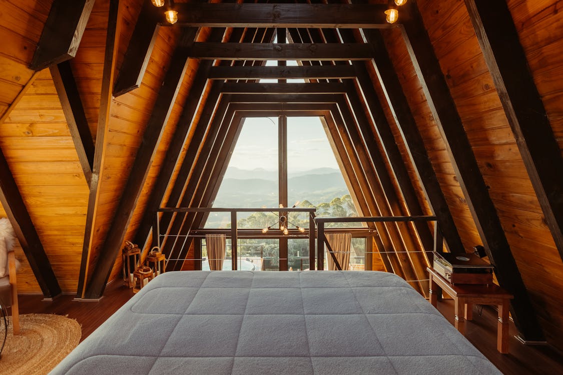 Free Wide Bed in a Luxury Wooden Cabin with a Scenic Mountain View Stock Photo