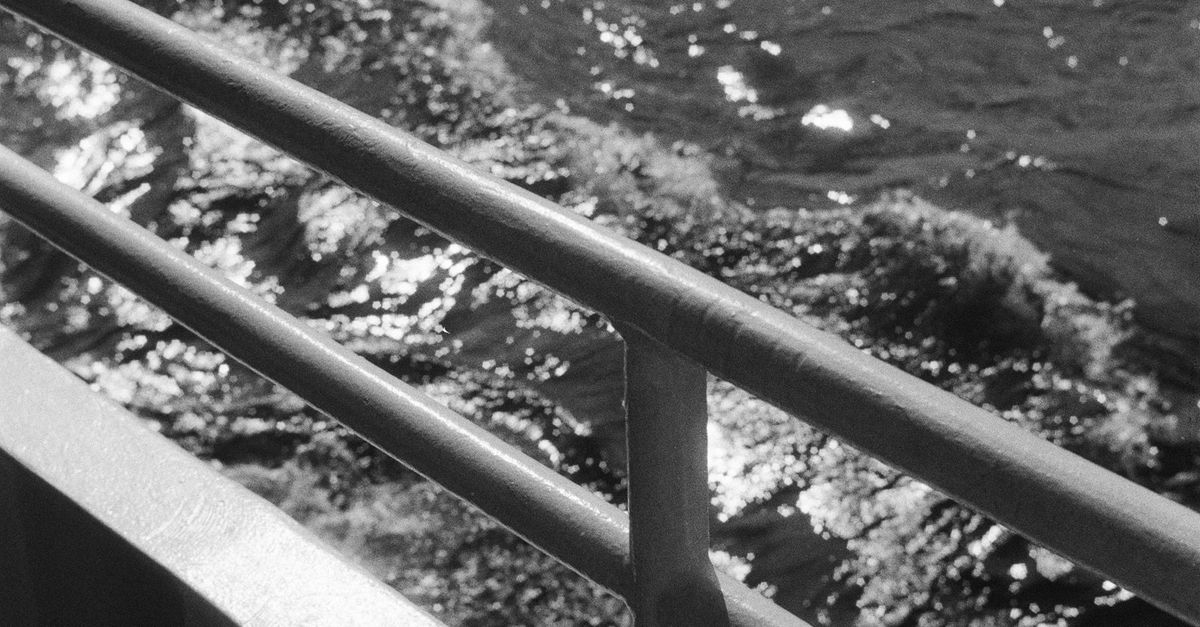 Wavy Water behind Vessel Railing · Free Stock Photo