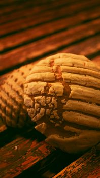 Delicious Mexican conchas featured in a rustic setting, emphasizing sweet bread texture.