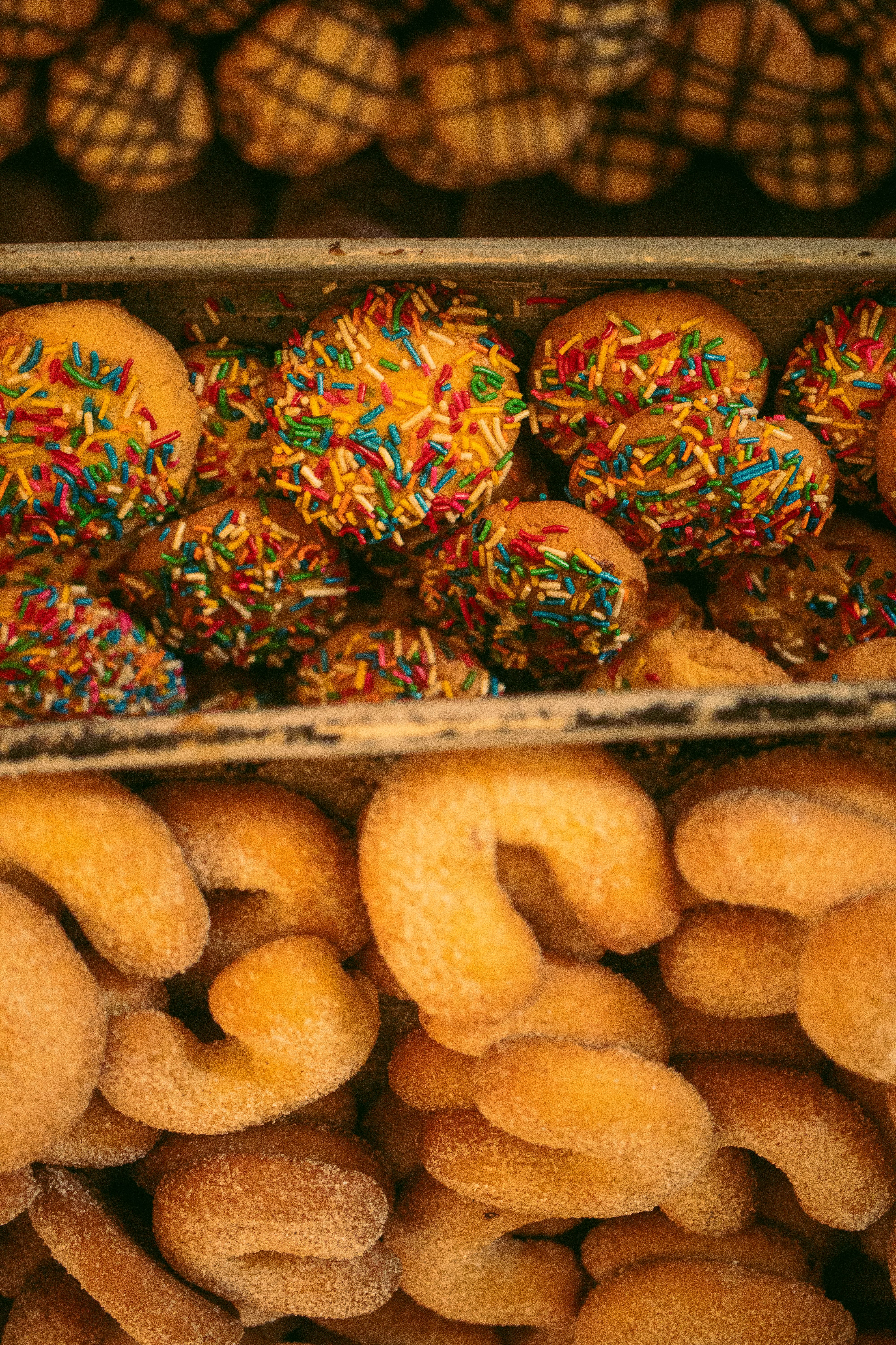 Close-up of traditional Mexican pan dulce topped with colorful sprinkles, showcasing vibrant bakery treats.
