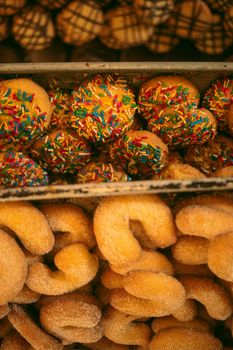 Close-up of traditional Mexican pan dulce topped with colorful sprinkles, showcasing vibrant bakery treats.