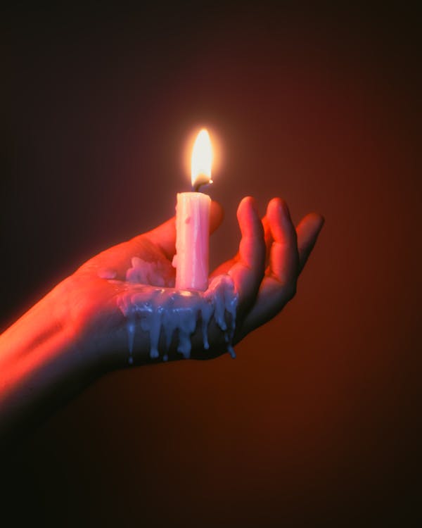 Melting wax candle of hand holding smart phone, illustration - Stock Image  - C039/5247 - Science Photo Library
