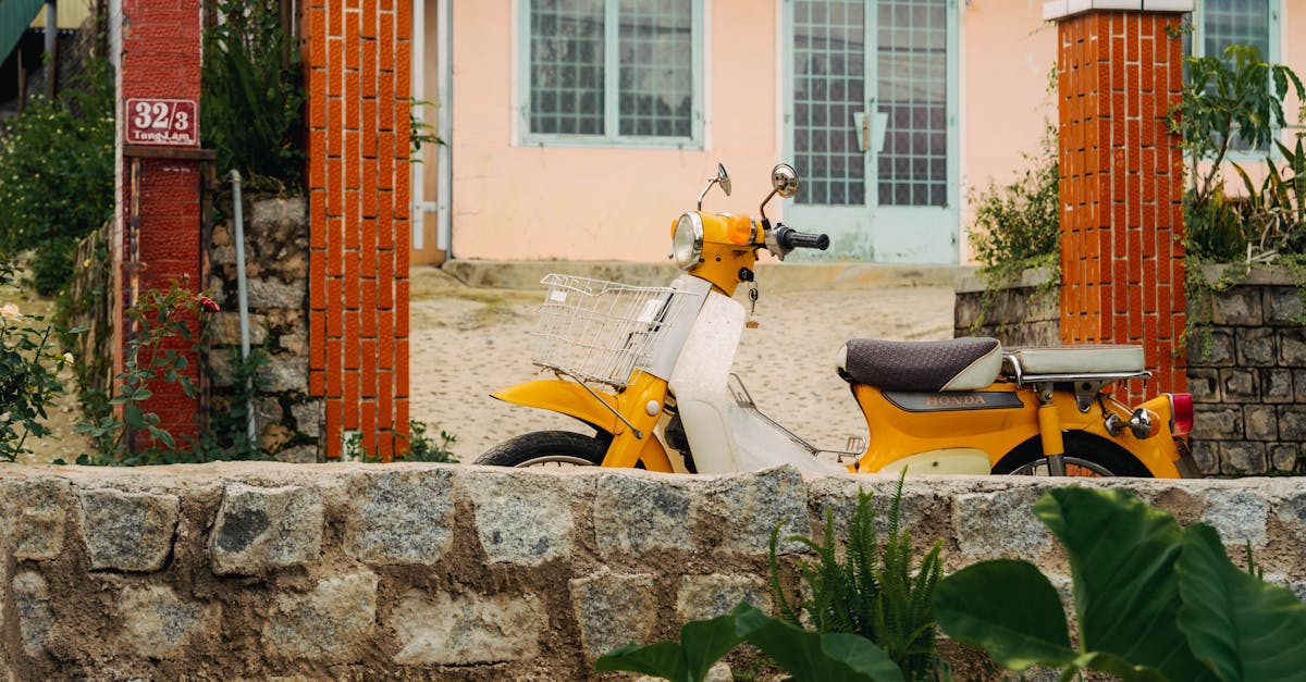 Bright yellow motorbike parked outside a charming Vietnamese home in Dalat, Vietnam.