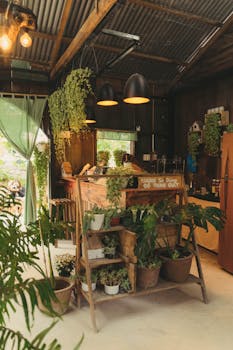 Cozy indoor space with lush plant decor and rustic design elements, bathed in natural light.