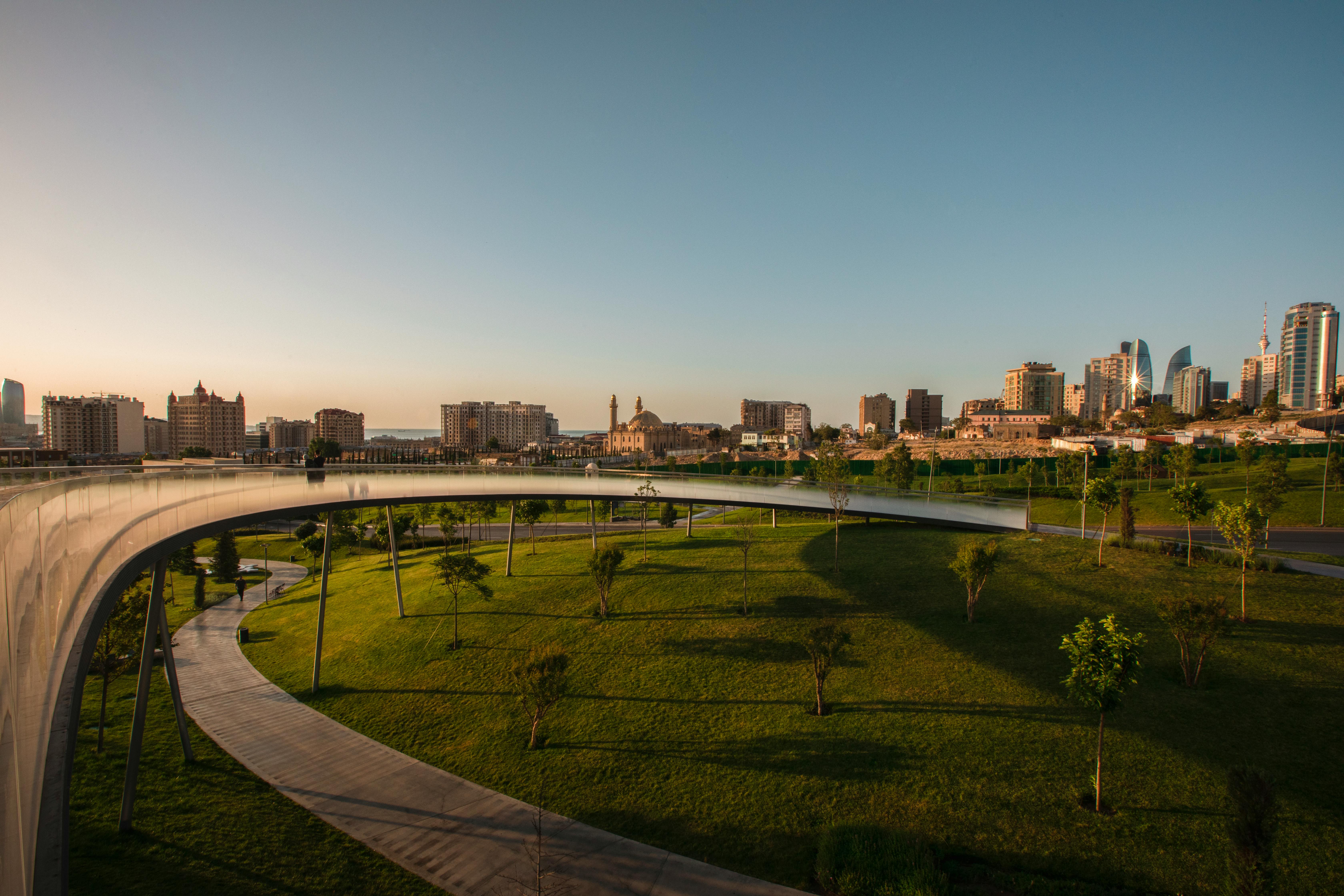 Elegant architecture and green park in Baku, Azerbaijan during early sunrise.