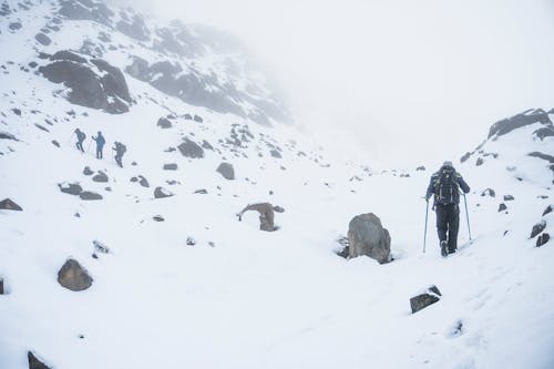 People Hiking in Mountains in Snow