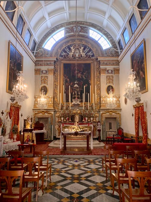 Free Beautifully decorated church interior featuring ornate altar and chandeliers. Stock Photo