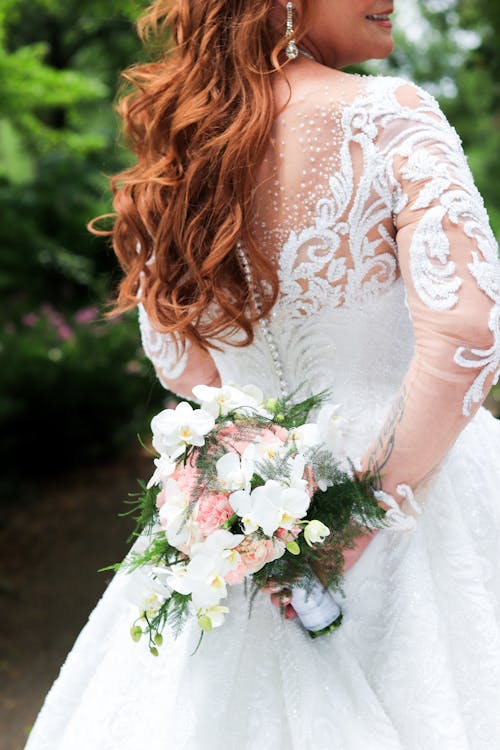Bride Holding a Bouquet of Flowers behind her Back 