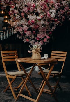 Cozy patio setting with wooden furniture and vibrant floral backdrop in Chisinau, Moldova.