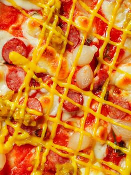 Mouthwatering pizza topped with sausage, onions, and mustard for a savory, tangy twist.