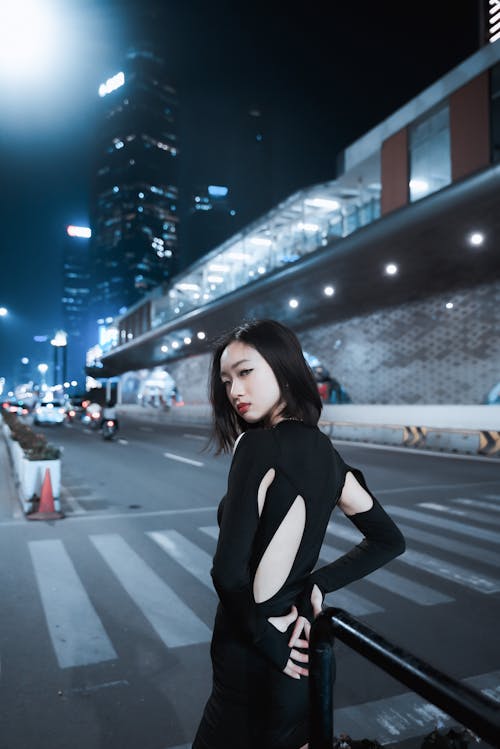 Young Woman Standing on Night City Street